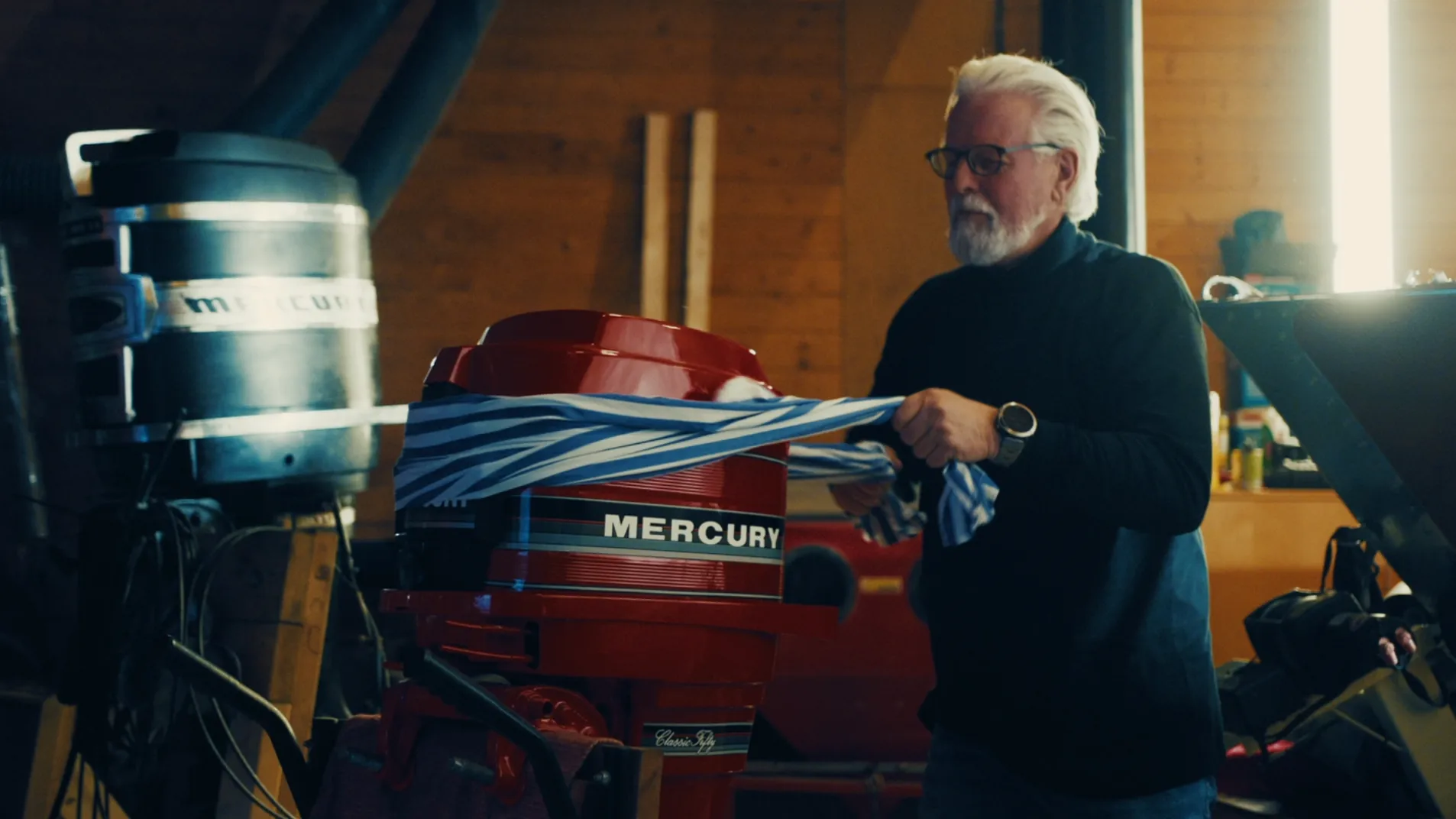 Gert Gill puser båtmotor. Skjermbilde fra kampanjefilm 2025.